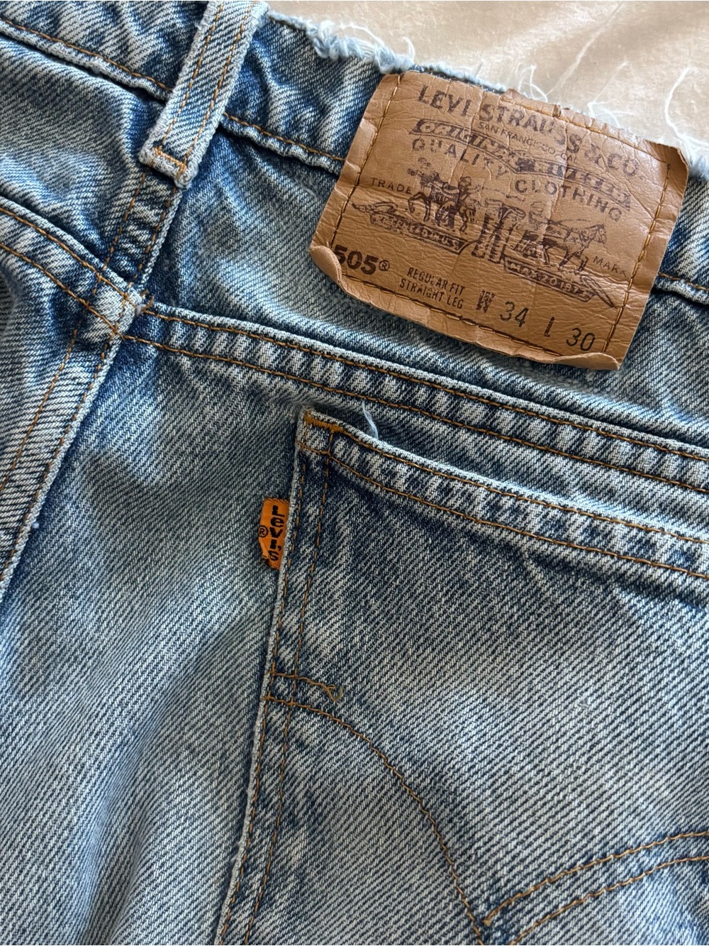 Levi's vintage orange tab 505 denim jeans with tan leather patch